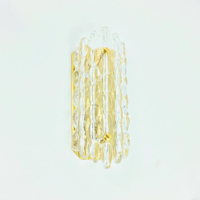 Stunning wall light designed by Carl Fagerlund for Orrefors (Sweden, 1960s). Transparent art glass shade fixed with two...