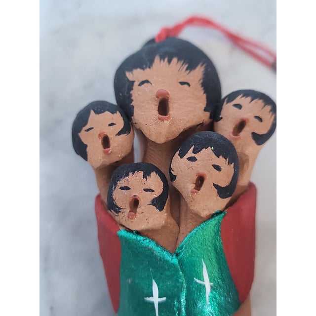 Jemez Pueblo potters coils and shapes story teller figures from locally gathered clay, fire them over an open kiln, then...