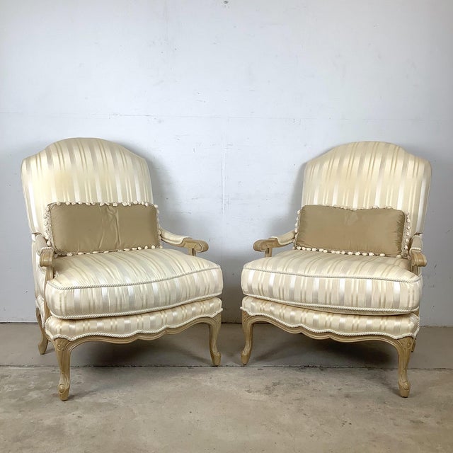 This refined pair of bergère armchairs reflects the elegant curves and comfort-driven design traditionally associated with...