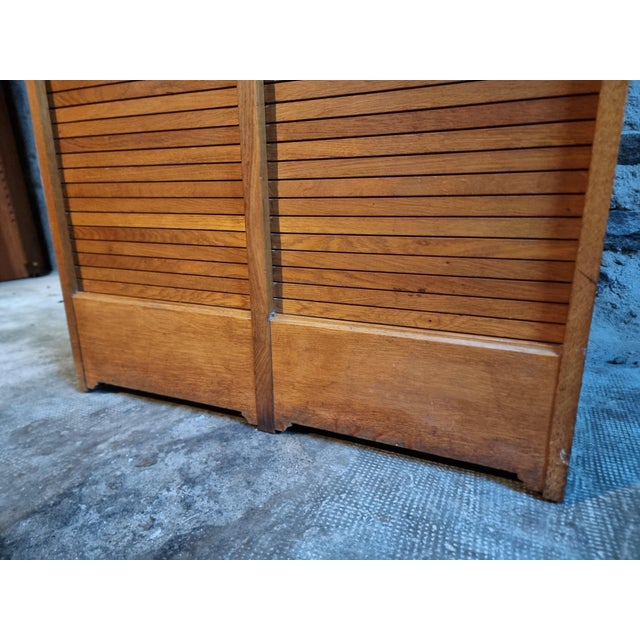 This vintage French oak tambour cabinet dates from the 1960s and showcases the refined craftsmanship typical of mid-...