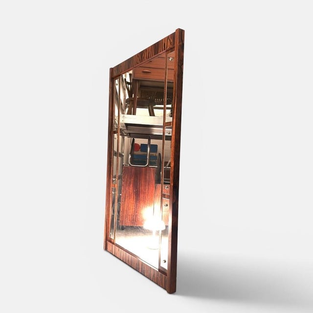 Danish wall mirror executed by a danish cabinetmaker during the 1960s. the frame is crafted with expressive grain patterns...