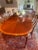 A Queen Anne Style oval Dining Table by high quality furniture maker Hickory Chair. Mahogany with banded edge and sunburst...