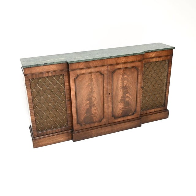 An impressive and very well made antique marble top grill front sideboard in the classic Georgian style. This was made in...