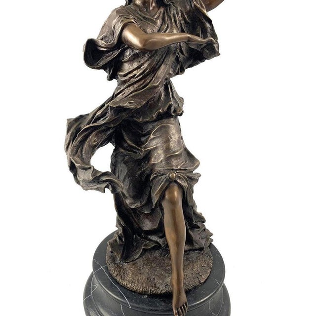 A fine french cast bronze of a female dancer. Dark brown patination. With long flowing robes and outstretched arm....