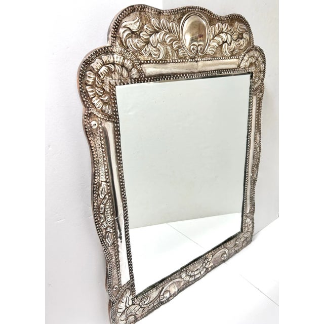 A stunning and very large, embossed, handcrafted sterling silver repoussé mirror featuring intricate embossed metalwork....