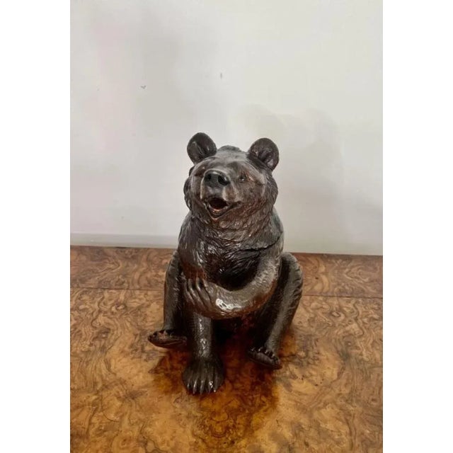 Large antique 19th century Victorian quality carved Black Forest bear in a seated position, with the original glass eyes,...