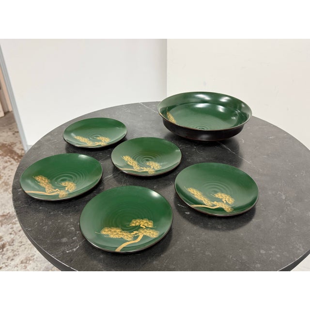Design Plus Gallery presents a Japanese Lacquerware Plate + Bowl Set. The pieces have deep green lacquered surfaces...