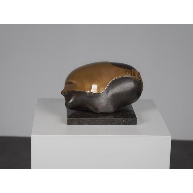 A refined abstract bronze sculpture by Dutch artist Jos van Vreeswijk. The work combines a rounded, almost organic upper...