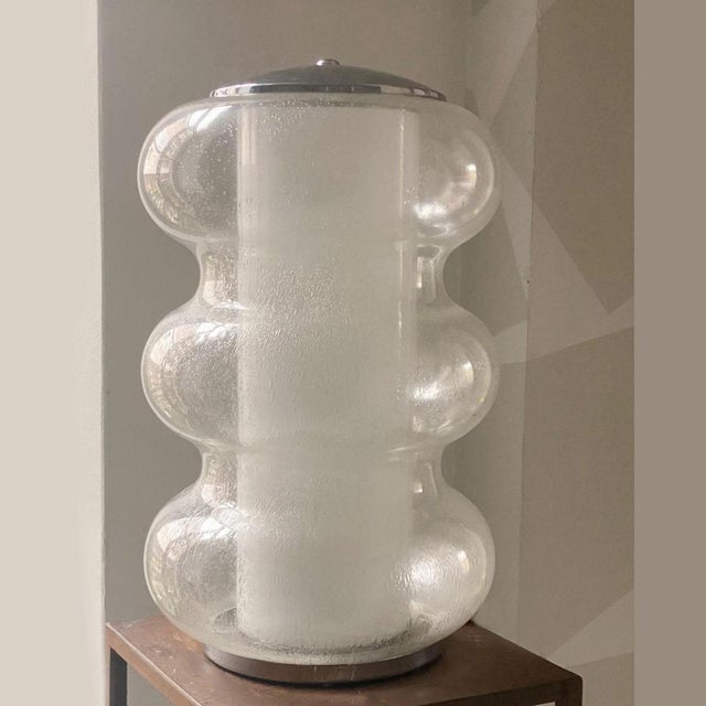 Rare sculptural hand blown table lamp from Mazzega, Murano 1970's, composed of a curvaceous outer glass in Pulegoso glass...