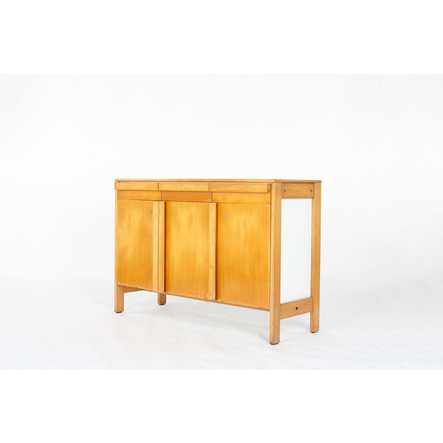 Storage unit made by Andre Sornay in the sixties Rare model Beech structure and melamine panels 3 doors and 3 drawers Some...