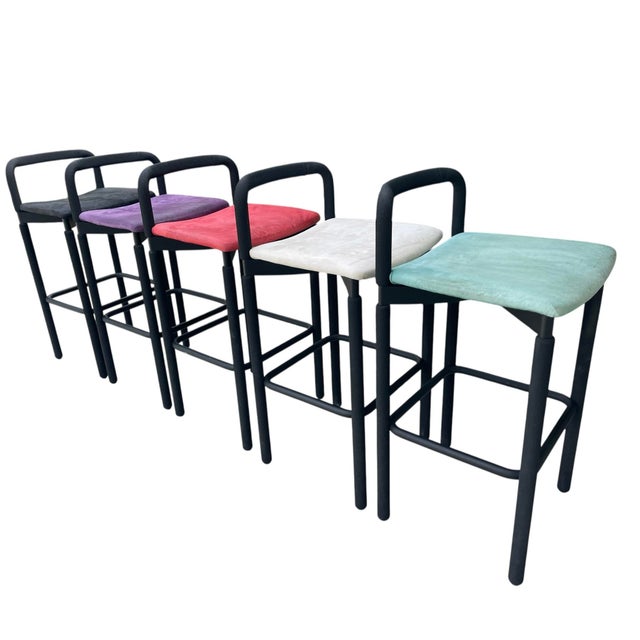 Striking set of five postmodern bar stools in black textured polyurethane over tubular steel, attributed to Brian Kane for...