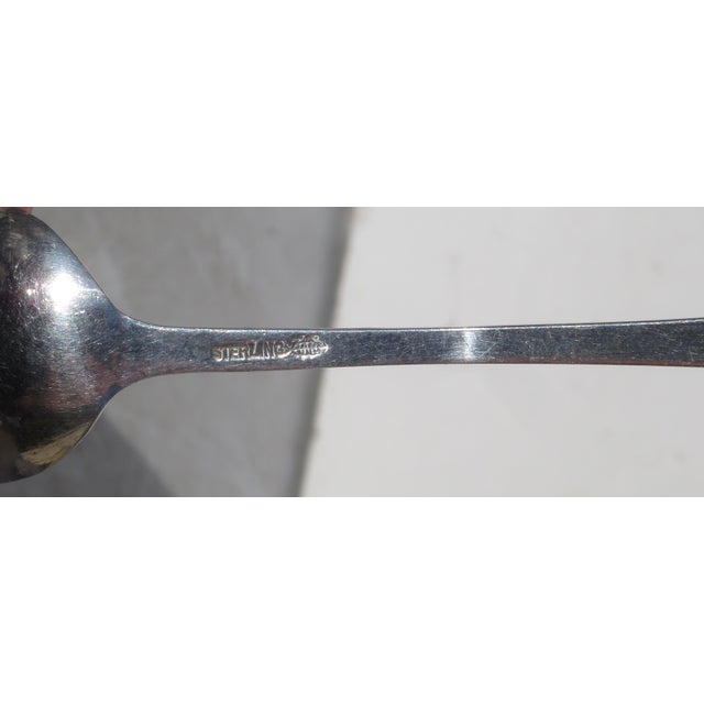 Large chocolate serving spoon with pierced handle. Marked Sterling and Webster Co. The measurements are 5.4" long and 1.1"...