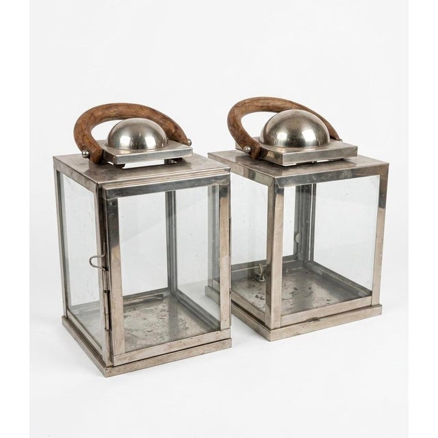 This striking pair of vintage lanterns seamlessly blends industrial structure with organic warmth. Crafted from polished...