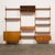 A beautiful 1960s Danish Mid-Century teak wall-mounted system with adjustable shelves and cabinets. This innovative mid-...