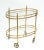 Superb bar cart made by Maison Bagués in France circa 1950. Features 2 tier glass shelves with brass detail in oval shape....