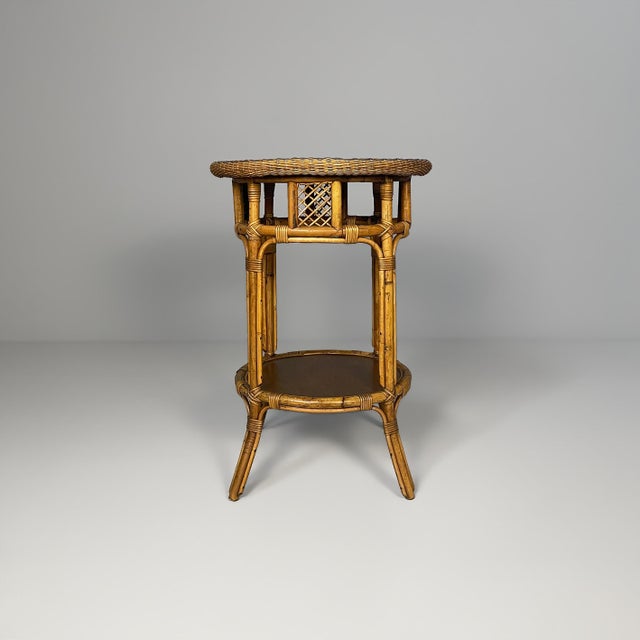 Italian modern bamboo coffee table, 1970s Honey-colored bamboo and rattan coffee table with a circular dark wood top edged...