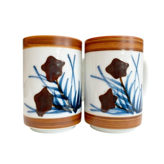Elevate your coffee experience with the Holt Howard Stoneware Coffee Mug Set, featuring an exquisite abstract blue flowers...