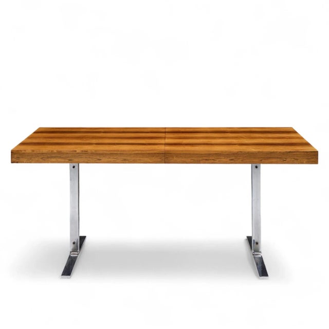 Poul Norreklit for Georg Petersens Mid Century Danish Rosewood and Chrome Hidden Leaf Expanding Dining Table This table...