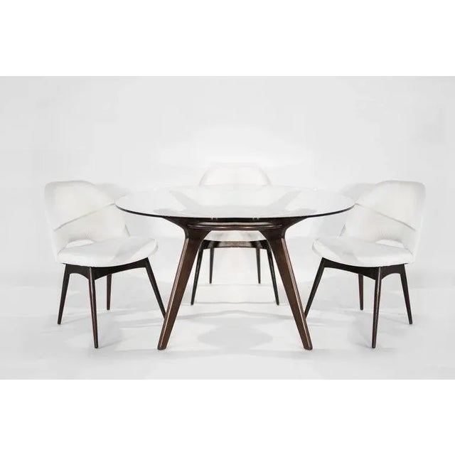 Compass dining table, paired with Model 1404-C chairs designed By Adrian Pearsall for Craft Associates, circa 1950s. The...