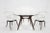Compass dining table, paired with Model 1404-C chairs designed By Adrian Pearsall for Craft Associates, circa 1950s. The...