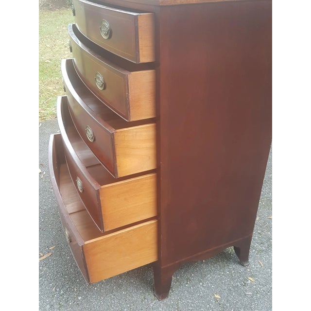 This is a fine 20th-century mahogany bowfront chest of drawers. It features stunning flame patterns on the drawers, top,...