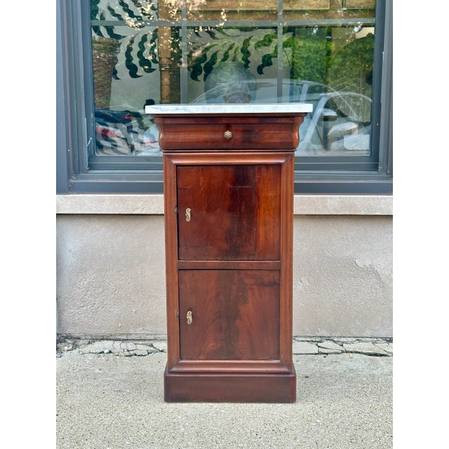 French Louis Phillippe bed-side table in mahogany with double doors and top fitted with white marble, H - 31’’ / D- 15”/...