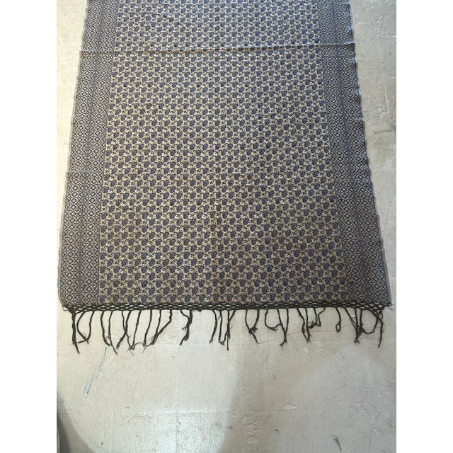 The fabric was never used all over design blue color with fringes. You can use it as a table cover over the couch . It is...