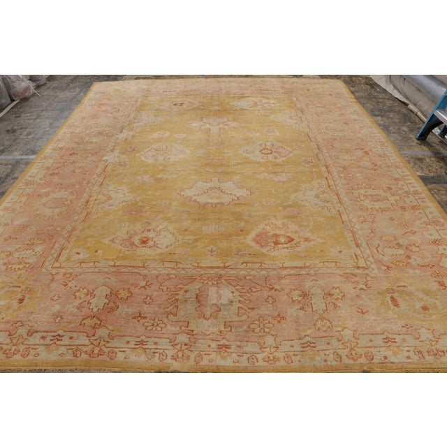 Made with hand-knotted wool and originating from Turkey circa 1910-1920, this 10x13 antique Oushak rug is an especially...