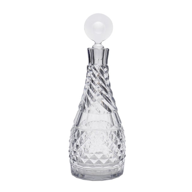 An English mallet-form decanter, cut and blown in the Georgian period, circa 1810. A slice-cut lip sits above a broad...