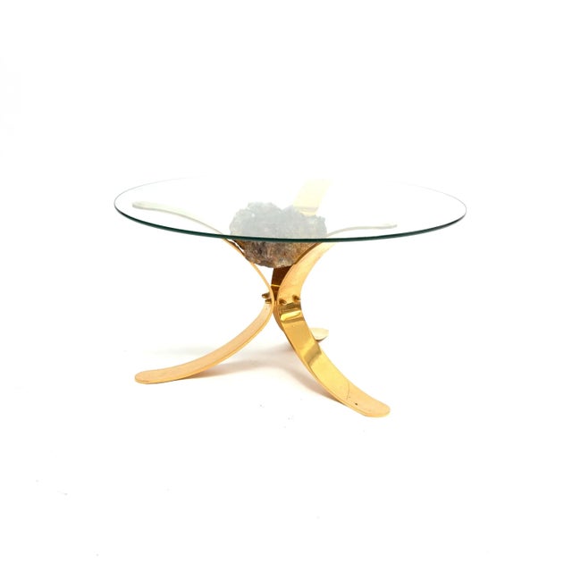 Unique Hollywood Regency coffee table from the 1970s, featuring a brass frame and glass top in the style of Jacques Duval-...