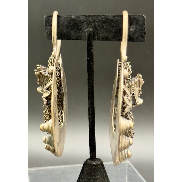 These vintage Asian Miao people tribal silver earrings are a unique find. Handcrafted silver earrings with circular...