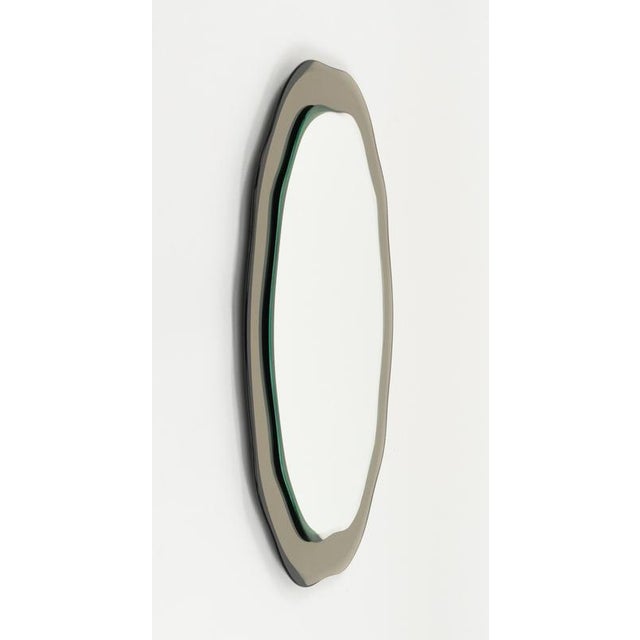 Midcentury amazing gray beveled edged wall mirror in the style of Fontana Arte. Made in Italy in the 1970s. The gray glass...
