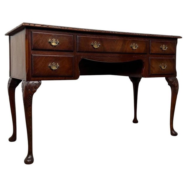 A handsome early 20th-century English writing table, finely crafted from mahogany and distinguished by its elegant...