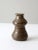 This vintage, handmade pottery vase features a unique hourglass shape with intricate ribbed detailing. Its warm, brown...