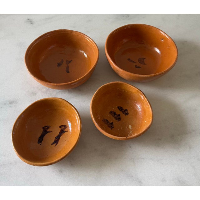 Set of 4 vintage yellowware pottery clay bowls, including 2 larger 6" bowls and 2 smaller 4.75" bowls. Hand made and...