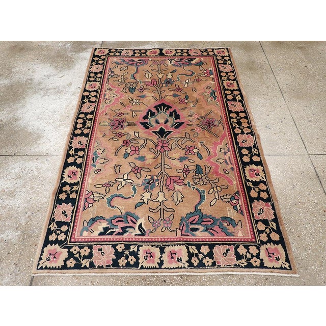 An antique Indian Lahore accent rug. Black and peach are the main tones in this north Indian scatter. A giant palmette...