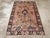 An antique Indian Lahore accent rug. Black and peach are the main tones in this north Indian scatter. A giant palmette...