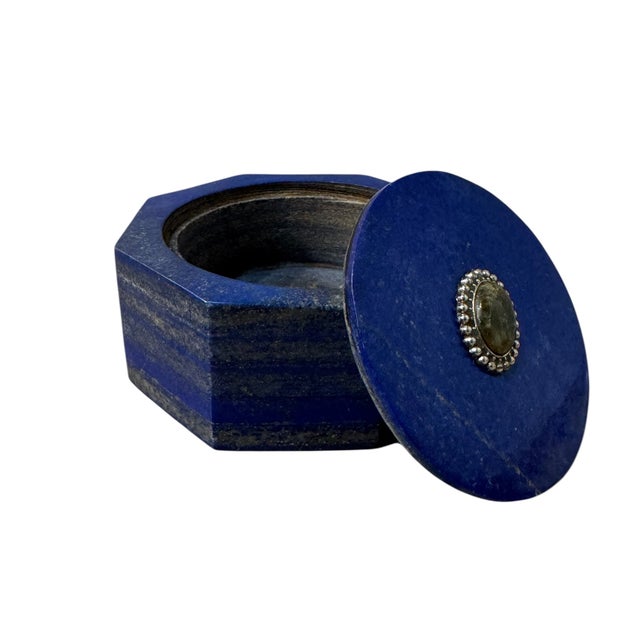 4 1/4”W x 2”H x 4 1/4”D An exquisite miniature sculpture, this Lapis Lazuli box transforms utilitarian storage into a work...