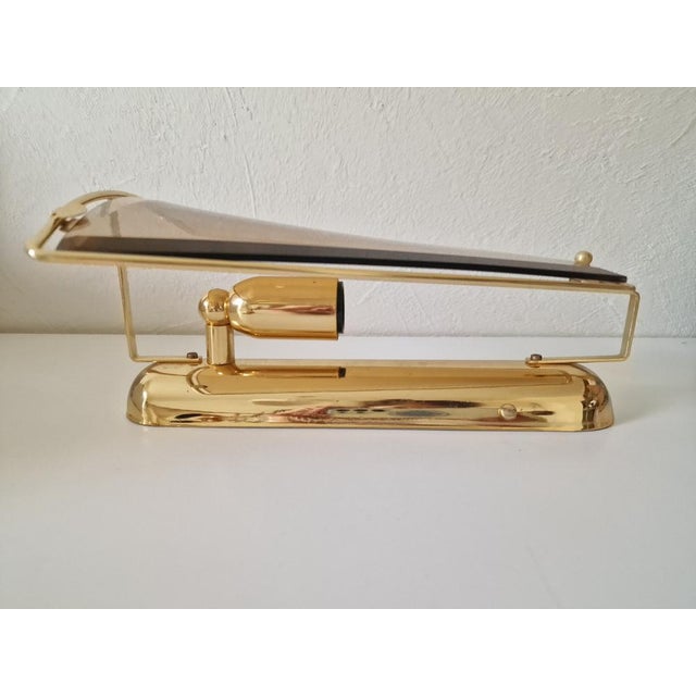 Rare! Pair of wall sconces by Lakro Amstelveen, a Dutch lighting manufacturer. Made of brass and beveled smoked glass....