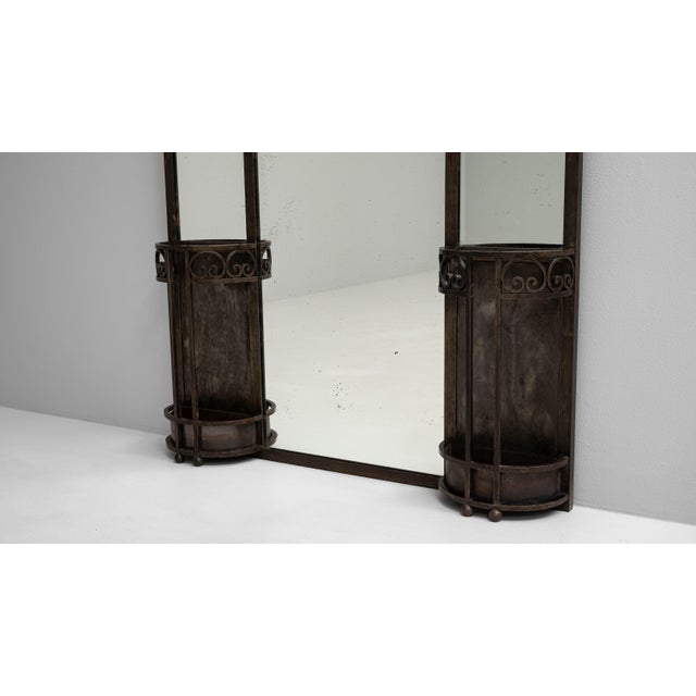 This 1910s French wrought iron mirror with coat rack and stand is a striking example of early 20th-century functional...