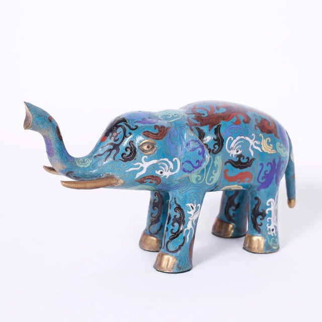 Enchanting pair of Chinese cloisonné or enamel on copper elephants decorated with symbolic biomorphic designs on an...