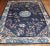 an early 20th Century hand-knotted one of a kind Chinese Peking Carpet with a floral design on a navy field. Professionaly...