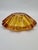 A striking bowl crafted from thick, pressed glass in a beautiful amber (honey) color. Its distinctive, radiant form with...