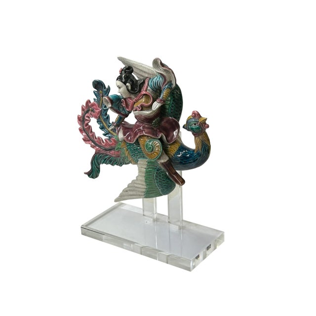 Imagine a Chinese vintage color ceramic warrior riding a phoenix figure, a captivating depiction that blends mythological...
