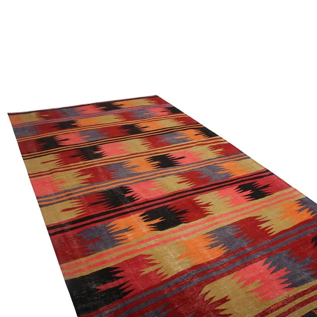 Hand woven in Turkey originating between 1950-1960, this vintage mid-century wool kilim hails from the Afyon province,...