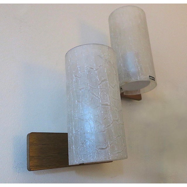 Pair of Doria cylindrical wall lights in frosted crackled glass on teak frames, 1960s. Doria label on front, Doria labels...