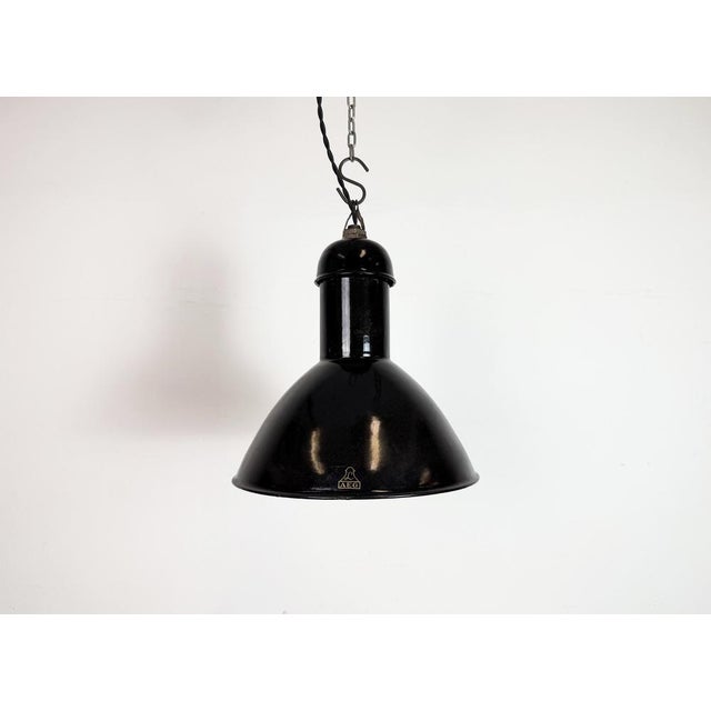 Vintage industrial factory lamp from the 1930s made by aeg in germany black enamel shade with white enamel interior iron...