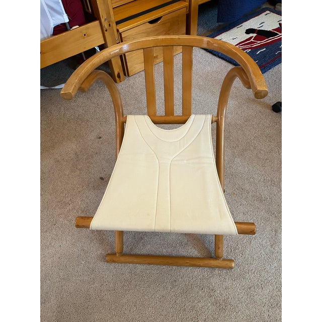 Unknown designer although in Thonet style. Two folding chairs with arms and upholstered seat stamped made in Romania....