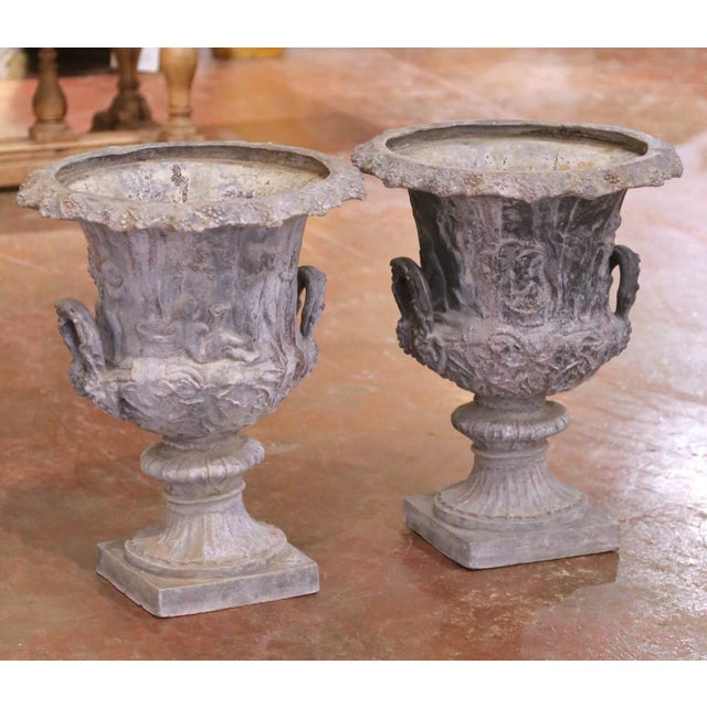 This substantial pair of antique-style French garden urns was crafted circa 1950 and cast in heavy lead. Each classical...