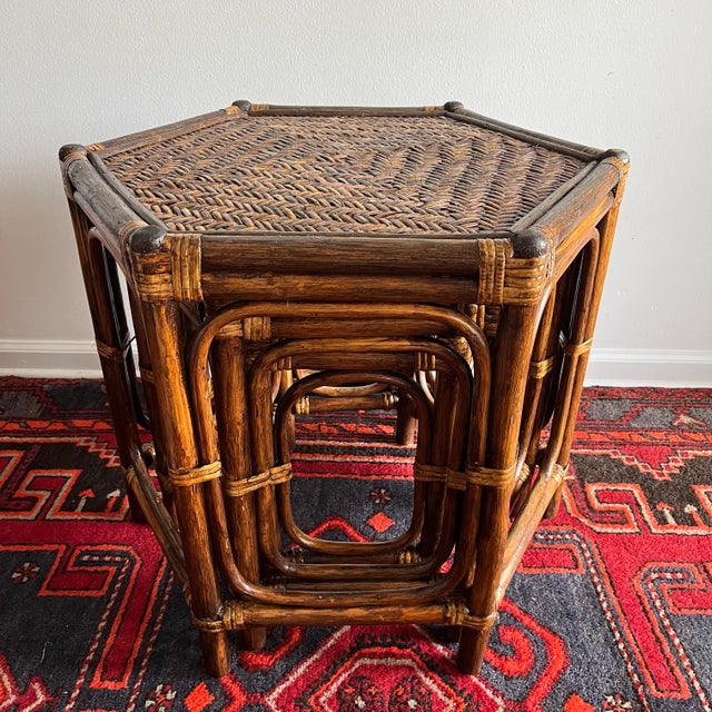 Vintage Set of three vintage nesting tables crafted from bent bamboo and handwoven rattan. The hexagonal tops feature an...